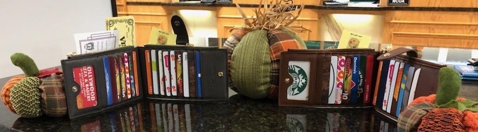 Picture of Brown and Gray wallets full of gift cards