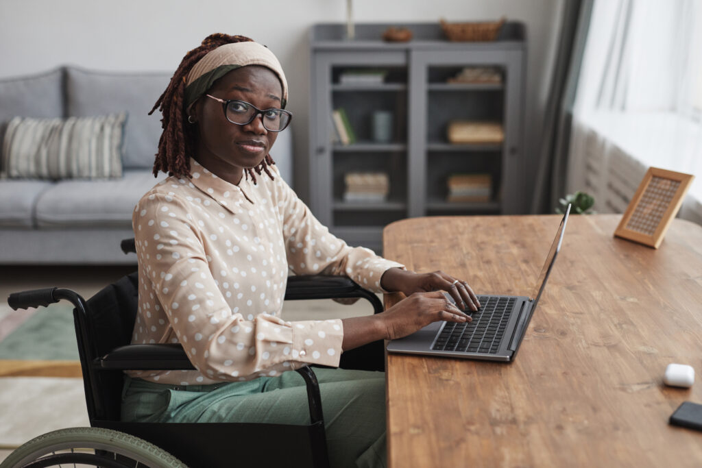 African American Woman in Wheelchair using Laptop