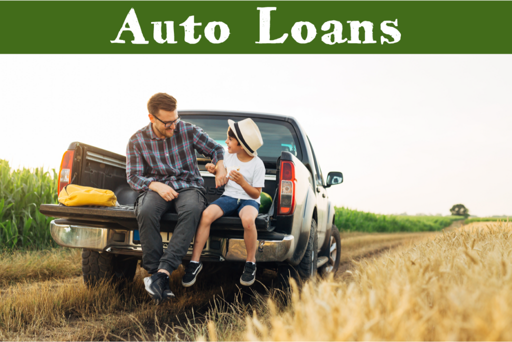 Auto Loans - father and son sit on truck tailgate